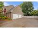 Exterior elevation of a home with a two-car garage and brick accents at 3510 Smoke Rise Way, Lawrenceville, GA 30044