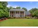 Beautiful two-story brick home with a well-manicured lawn and a charming blue front door at 3510 Smoke Rise Way, Lawrenceville, GA 30044