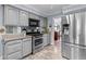 Charming kitchen features stainless steel appliances, granite countertops, and light gray cabinetry at 3510 Smoke Rise Way, Lawrenceville, GA 30044