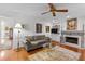 Comfortable living room with a fireplace, hardwood floors, and lots of natural light at 3510 Smoke Rise Way, Lawrenceville, GA 30044