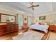 The main bedroom has tray ceilings, hardwood floors and a king bed at 3510 Smoke Rise Way, Lawrenceville, GA 30044