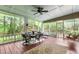 The screened porch features comfortable seating, a ceiling fan, and a porch swing, perfect for relaxing at 3510 Smoke Rise Way, Lawrenceville, GA 30044
