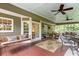 Enjoy the outdoors on this spacious screened porch with a swing, seating area, and view of the yard at 3510 Smoke Rise Way, Lawrenceville, GA 30044