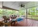 Inviting screened porch with wicker furniture and ceiling fan offers a relaxing outdoor living space at 3510 Smoke Rise Way, Lawrenceville, GA 30044