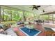 This screened porch offers comfortable seating and a view of the lush greenery, creating a serene atmosphere at 3510 Smoke Rise Way, Lawrenceville, GA 30044