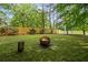 Fenced backyard featuring a fire pit, and lush greenery, perfect for outdoor entertaining and relaxation at 3927 Collier Nw Trce, Kennesaw, GA 30144