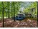 View of the backyard, deck, patio and screened porch surrounded by mature trees at 3927 Collier Nw Trce, Kennesaw, GA 30144