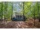 Wooded backyard with mature shade trees, deck, screened porch, and patio at 3927 Collier Nw Trce, Kennesaw, GA 30144