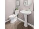 Half bathroom featuring tile flooring, a pedestal sink, a round mirror and neutral-colored walls at 3927 Collier Nw Trce, Kennesaw, GA 30144