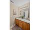Bathroom with double sinks, granite countertop, wood cabinets and a decorative rug at 3927 Collier Nw Trce, Kennesaw, GA 30144