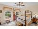 Cozy bedroom features a beautiful four poster bed, antique trunk, and natural light from two windows at 3927 Collier Nw Trce, Kennesaw, GA 30144