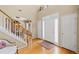 Inviting foyer featuring hardwood floors, stairs, and transom windows for natural light at 3927 Collier Nw Trce, Kennesaw, GA 30144
