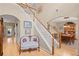 Inviting foyer featuring hardwood floors, staircase, and elegant decor, with dining area visible through archway at 3927 Collier Nw Trce, Kennesaw, GA 30144