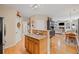Bright kitchen with wooden cabinetry, granite countertops and an entryway to the living room, dining room and hallway at 3927 Collier Nw Trce, Kennesaw, GA 30144