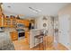 Well-lit kitchen with stainless steel appliances, granite countertops, wooden cabinets and a breakfast bar at 3927 Collier Nw Trce, Kennesaw, GA 30144