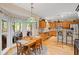 Eat-in kitchen featuring wood floors, a breakfast table overlooking the screened-in porch, and wooden cabinetry at 3927 Collier Nw Trce, Kennesaw, GA 30144