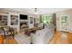 Open living room with hardwood floors, built in shelves and fireplace, flowing natural light and back patio access at 3927 Collier Nw Trce, Kennesaw, GA 30144
