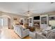 Spacious living room featuring a stone fireplace, built-in shelving and light hardwood flooring at 3927 Collier Nw Trce, Kennesaw, GA 30144