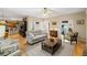 Cozy living room with hardwood floors, neutral color palette, and entryways to the kitchen, office, and front of the home at 3927 Collier Nw Trce, Kennesaw, GA 30144