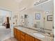 Primary bath featuring double sinks with granite countertops, vanity and large mirror at 3927 Collier Nw Trce, Kennesaw, GA 30144
