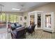 Enclosed patio with multiple seating areas and view to the wooded backyard at 3927 Collier Nw Trce, Kennesaw, GA 30144