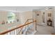 A view of the staircase and landing featuring neutral walls, white railing and carpeted stairs at 3927 Collier Nw Trce, Kennesaw, GA 30144