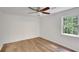 Bedroom featuring hardwood floors, a ceiling fan, and a window offering natural light at 4368 Heritage Glen Ct, Marietta, GA 30068