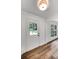 Fresh and bright entryway with white door with window, freshly painted white trim and hard wood flooring at 4368 Heritage Glen Ct, Marietta, GA 30068