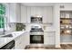 Bright kitchen featuring stainless appliances, white countertops and cabinets, and open shelving at 4368 Heritage Glen Ct, Marietta, GA 30068