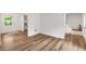 Bright living room with hardwood floors and white walls leading to the kitchen and staircase at 4368 Heritage Glen Ct, Marietta, GA 30068