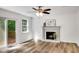 Bright living room boasts hardwood floors, a modern ceiling fan, and a cozy fireplace with slider to the rear deck at 4368 Heritage Glen Ct, Marietta, GA 30068