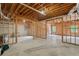 Spacious unfinished basement featuring framing and concrete floor, ready to be transformed into a customized living space at 5041 Corinault Nw Pl, Acworth, GA 30101