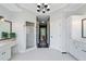 Bright primary bathroom features double sinks, walk in shower, and hall leading to primary bedroom at 5041 Corinault Nw Pl, Acworth, GA 30101
