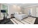 Well-lit bedroom with dark wood floors, an area rug, and modern exercise bike next to the bed at 5041 Corinault Nw Pl, Acworth, GA 30101