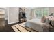 Stylish bedroom with dark wood floors, a fluffy area rug, and a view into the kitchen at 5041 Corinault Nw Pl, Acworth, GA 30101