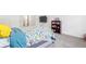 Comfortable bedroom featuring soft carpet, a wall-mounted TV, and a cozy bed with colorful bedding at 5041 Corinault Nw Pl, Acworth, GA 30101