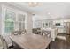 Bright dining area with window views, contemporary table, and open flow to kitchen at 5041 Corinault Nw Pl, Acworth, GA 30101