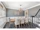 Dining room with modern light fixture, wainscoting and beautiful dark wood flooring at 5041 Corinault Nw Pl, Acworth, GA 30101