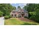 Charming brick home with a well-manicured lawn and lush landscaping at 5041 Corinault Nw Pl, Acworth, GA 30101