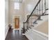 Bright foyer with tall ceilings, wood floors, and staircase with detailed banister at 5041 Corinault Nw Pl, Acworth, GA 30101