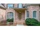 Inviting front entrance with brick detail, a covered porch, and decorative landscaping at 5041 Corinault Nw Pl, Acworth, GA 30101