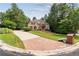 Charming brick home featuring well-manicured landscaping, a circular driveway, and a welcoming entrance at 5041 Corinault Nw Pl, Acworth, GA 30101