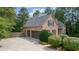 Brick home with an attached three-car garage, well-maintained landscaping, and a side entry door at 5041 Corinault Nw Pl, Acworth, GA 30101