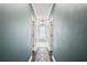 Hallway view leading to a luxurious bathroom with a soaking tub and chandelier at 5041 Corinault Nw Pl, Acworth, GA 30101
