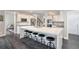 Bright, open kitchen features white cabinets, stainless steel appliances, and a large center island with seating at 5041 Corinault Nw Pl, Acworth, GA 30101