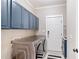 Functional laundry room with modern washer/dryer, storage cabinets, and stylish finishes at 5041 Corinault Nw Pl, Acworth, GA 30101