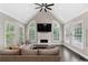 Bright living room featuring high ceilings, a fireplace, and expansive windows that provide natural light at 5041 Corinault Nw Pl, Acworth, GA 30101