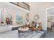Open-concept living room with tall ceilings, comfortable seating, and views of the entry at 5041 Corinault Nw Pl, Acworth, GA 30101