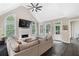 Bright living room with high ceilings, large windows, fireplace, and comfortable neutral-toned sectional sofa at 5041 Corinault Nw Pl, Acworth, GA 30101