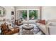 Bright living room featuring a seating area, large windows, and a view of the outdoor deck at 5041 Corinault Nw Pl, Acworth, GA 30101